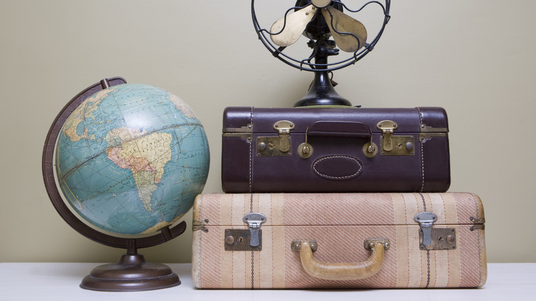 Vintage trunk boxes beside a globe