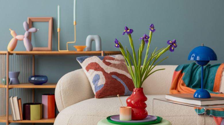 Colorful living room with flower vase on table and white sofa