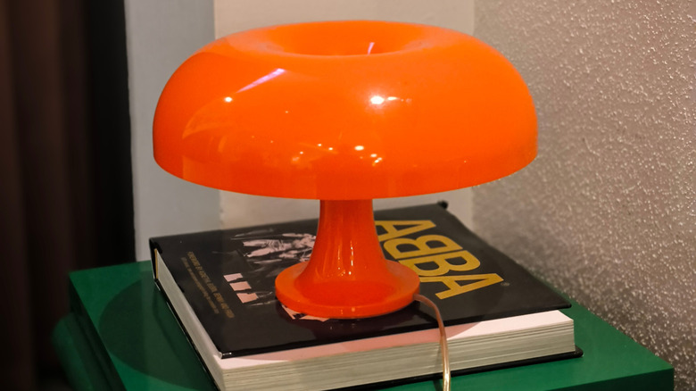 orange mushroom lamp on green cabinet