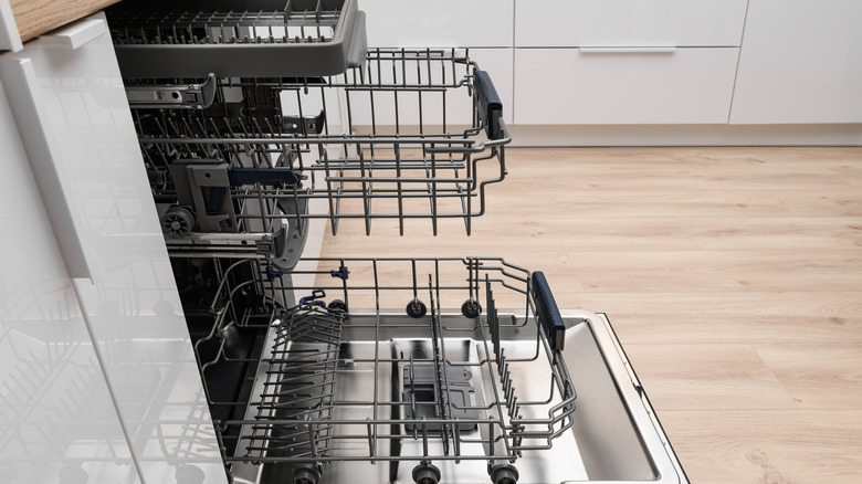 Empty dishwasher with door open and shelves pulled out