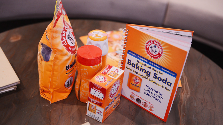 Several containers of baking soda sitting on a table
