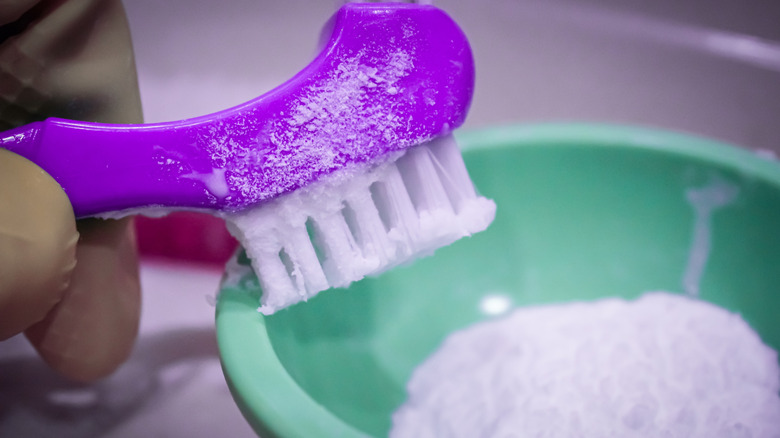 Purple brush covered with baking soda