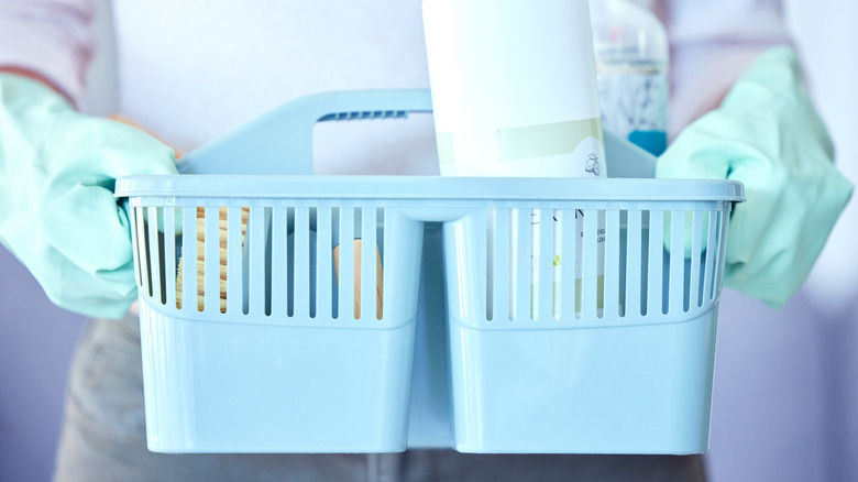 A person holding a shower caddy