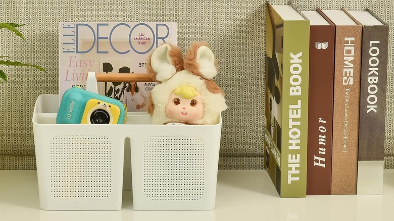White shower caddy with toys and magazine in living space
