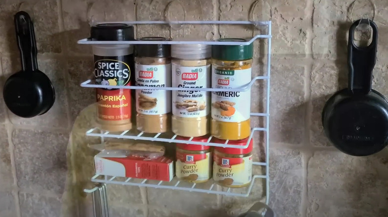 DIY shower caddy spice rack on kitchen wall