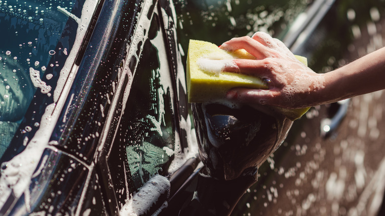 hand washing car with sponge