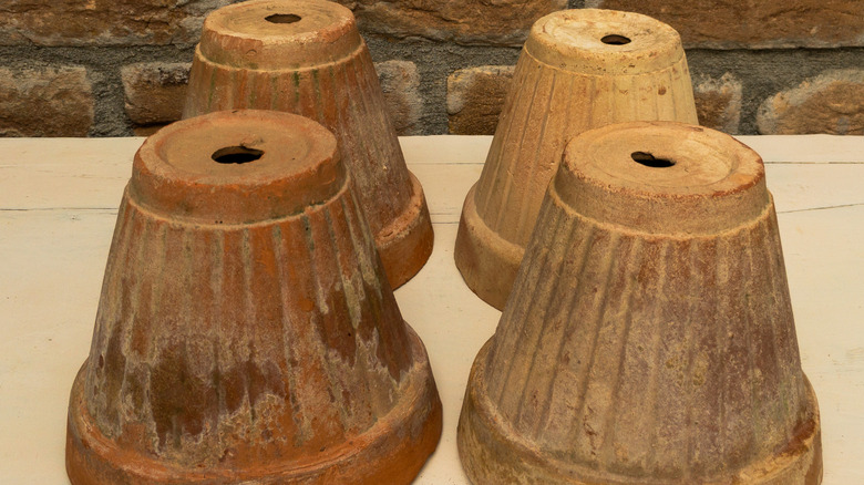 Upside down terracotta pots with tealights inside can be used to heat a greenhouse