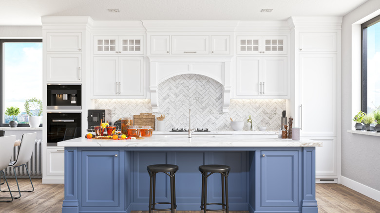 Updated kitchen with white cabinets that extend to the ceiling