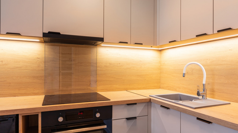 Strip lighting installed under the upper cabinets in a kitchen