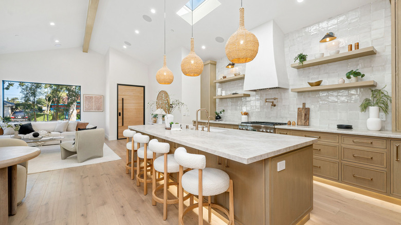 Open floating shelving on either side of the range hood on a tiled wall in a remodeled kitchen