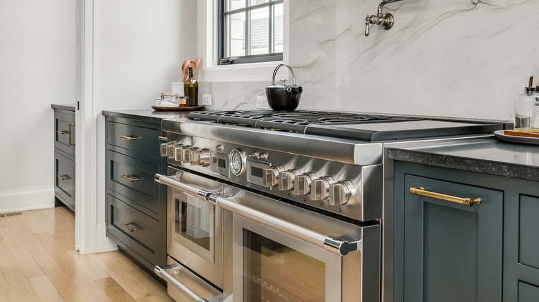 Large, luxury range with two oven doors and multiple knobs on the front panel