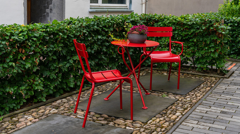 Two red chairs and a small table