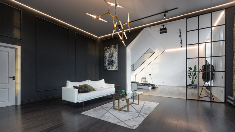 A black and white room with gold fixtures.