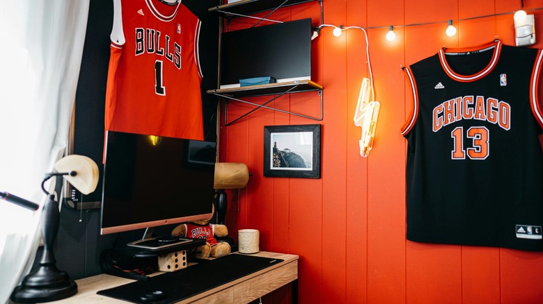 A neon orange accent wall in a child's bedroom.