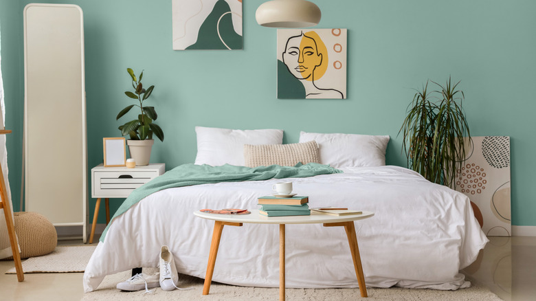 A turquoise bedroom with white and natural accents.
