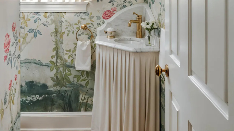 Vintage corner pedestal sink with pale pink pleated sink skirt