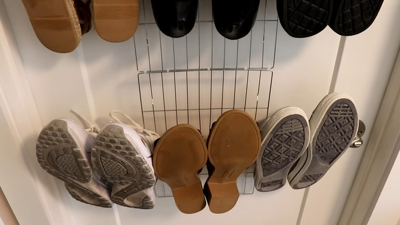 Shoes hanging on an over-the-door rack made from Dollar Tree cooling racks and hooks