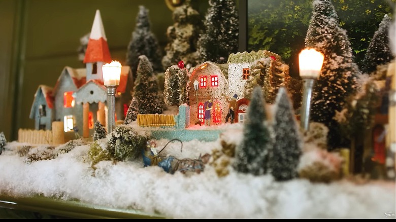 Vintage Christmas village with artificial trees and mini streel lights