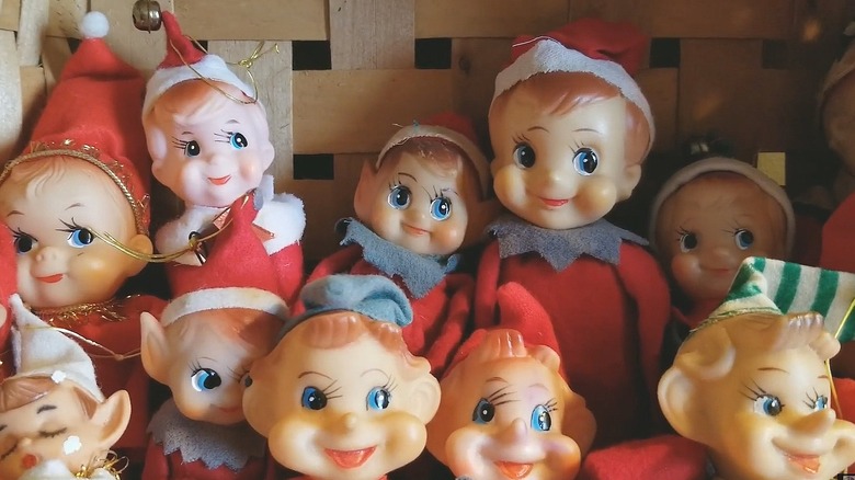 Collection of vintage elf figurines stacked in a basket