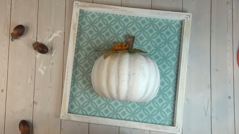 A 3D pumpkin wall art with a blue background