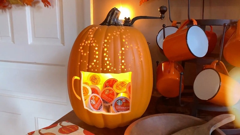 K-cups inside an orange foam pumpkin on a kitchen counter