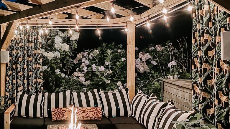 Patio with leopard-print curtains and striped pillows
