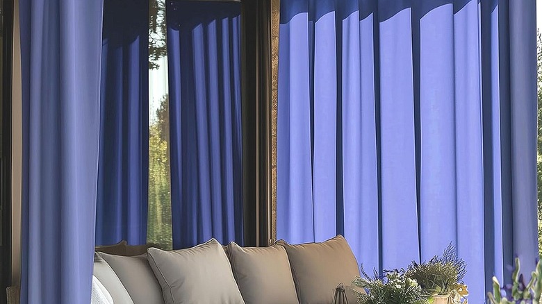 Deep purple curtains hanging around a patio