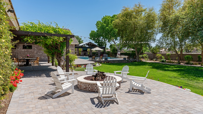 Spacious outdoor yard with chairs circling a fire pit