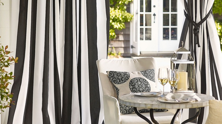 Black-and-white striped Sunbrella patio curtains