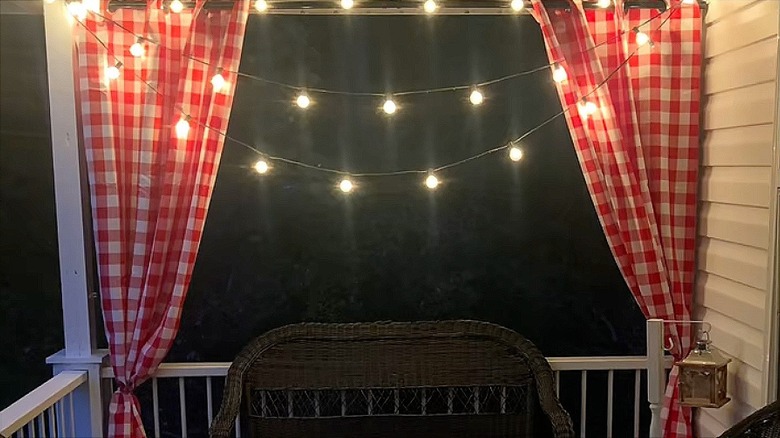 Red and white checkered curtains with string lights
