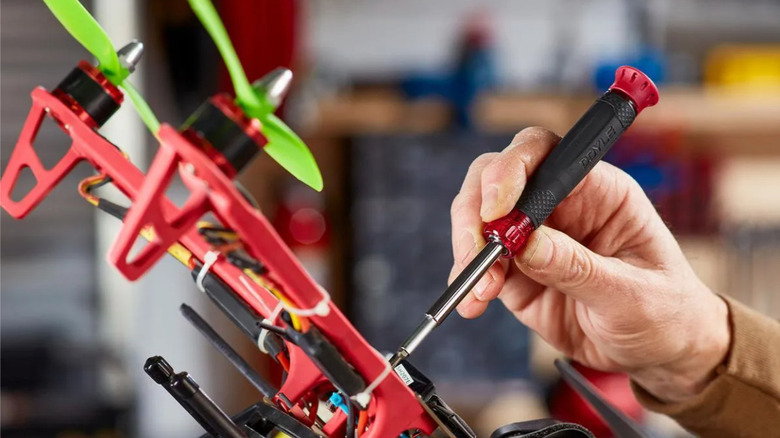 Close-up of hand using Doyle precision screwdriver