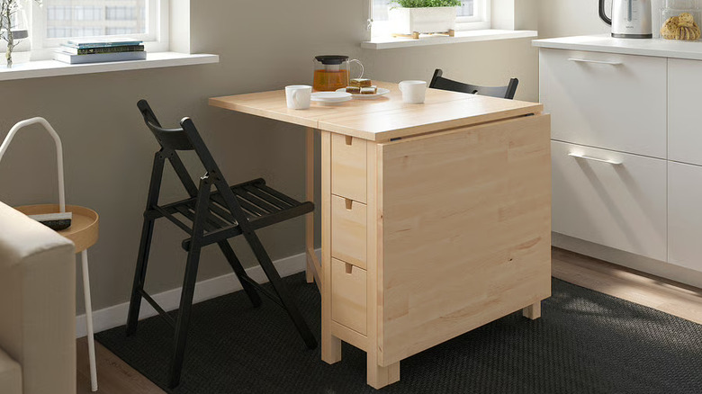 NORDEN gateleg table with chairs and tea and snacks on tabletop