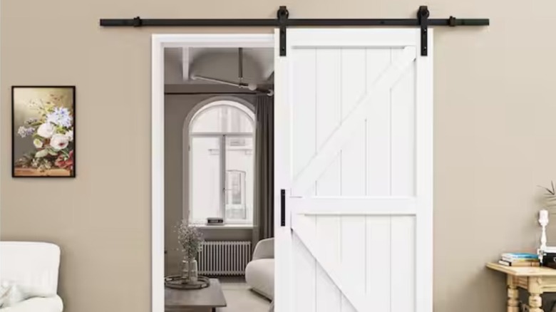 Close-up view of white sliding shiplap barn door