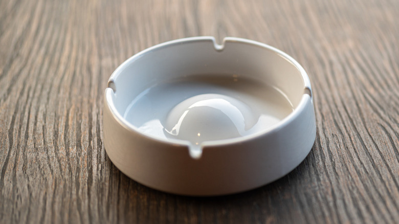 White ashtray on wooden table