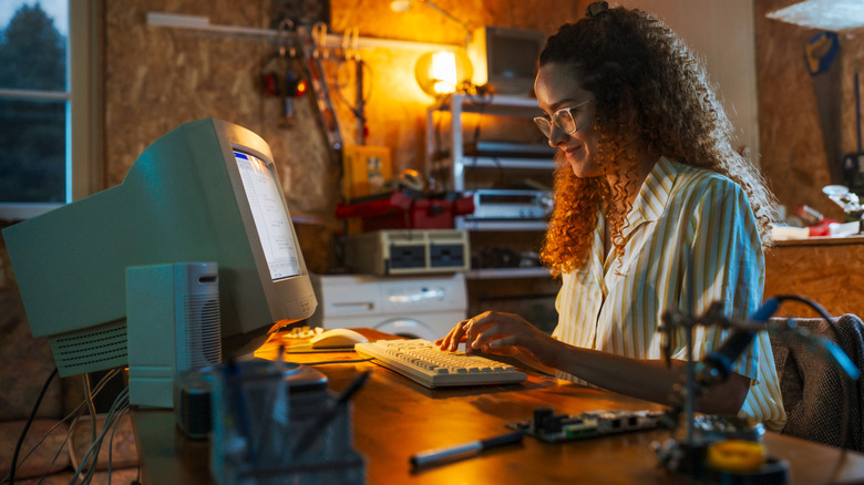Woman on vintage desktop computer