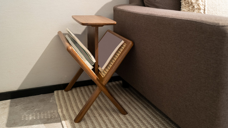 Magazine rack sitting next to couch