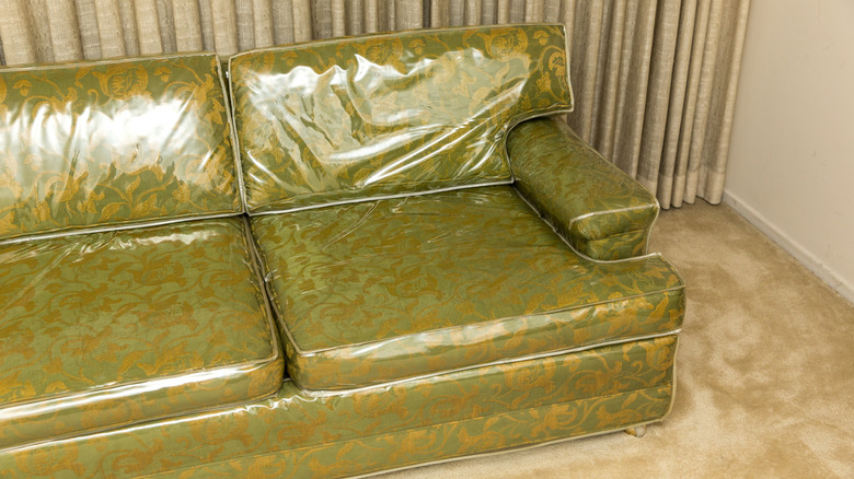 Plastic-covered green couch