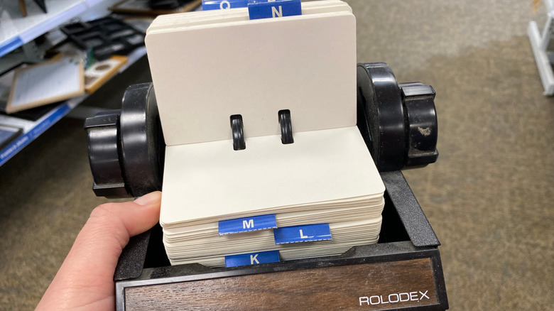 Person holding a Rolodex in a thrift store