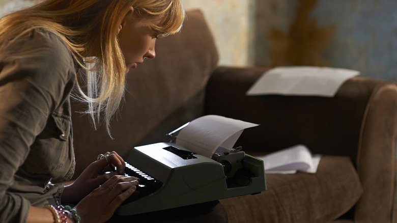 Woman typing on a typewriter