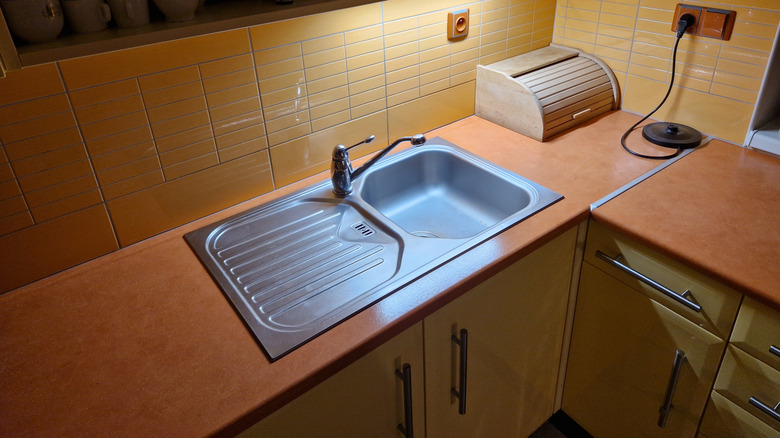 Kitchen with yellow cabinets and honey-brown countertops