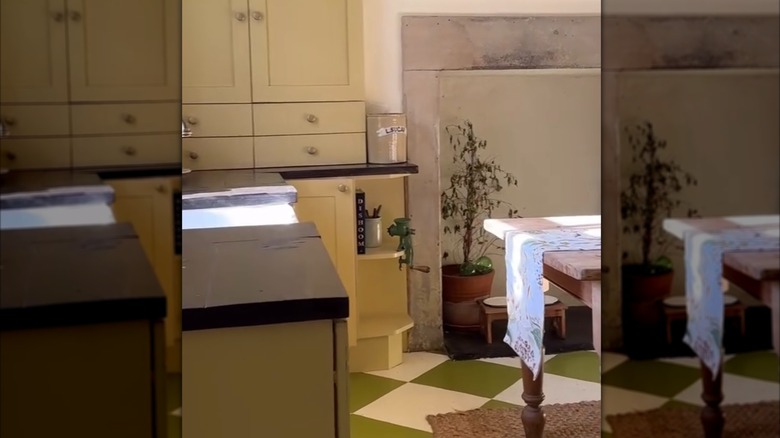 Butter yellow kitchen cabinets with sage green checkered floor