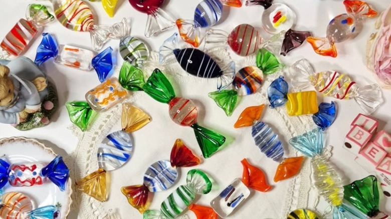A variety of colorful vintage glass candies on table.