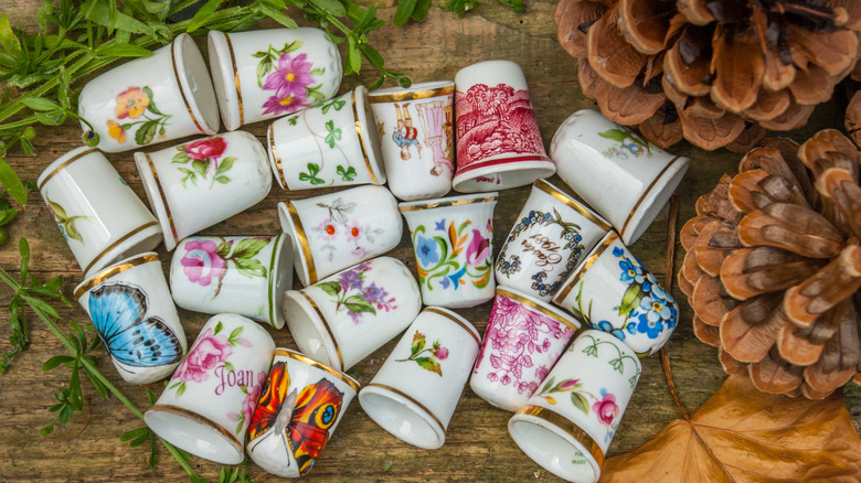 A pile of decorated porcelain thimbles.