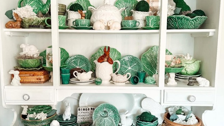 A collection of cabbageware displayed on shelf.
