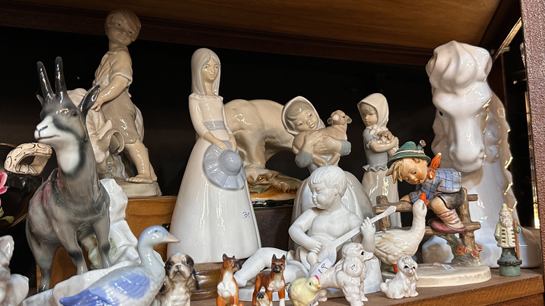 A mix of human and animal figurines and statues.
