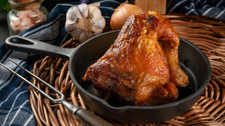 A roasted chicken in a cast iron skillet