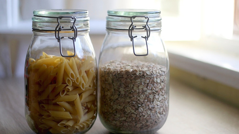 Mason jars in a kitchen with pasta stored inside them