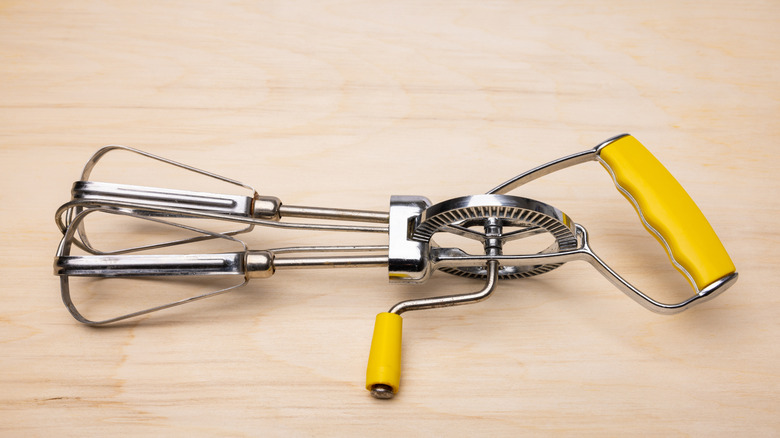 An old-school hand-cranked egg beater