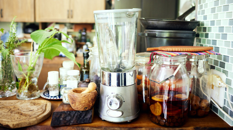 Blender standing out on cluttered kitchen countertop