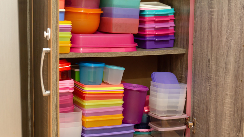 Organized kitchen cabinet with a variety of tupperware containers